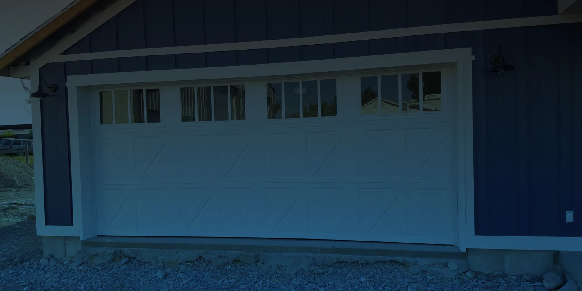 white garage door of a blue house