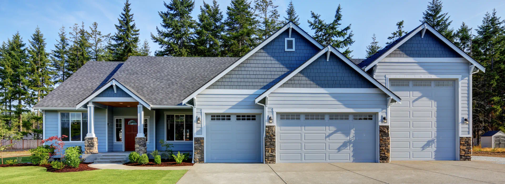 residential house with garage doors with different sizes